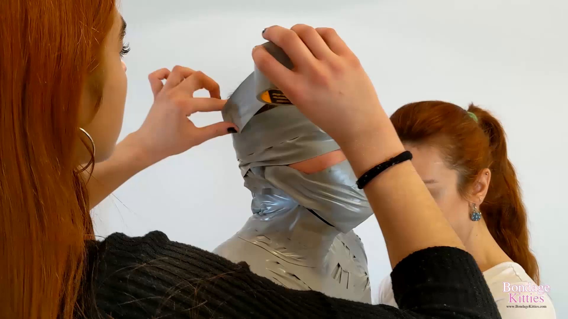 Bondage Kitties  dominant face sitting - Two girls mummify a friend as a birthday gift. Starring  00001