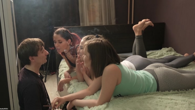 Beautiful Girls – Mistresses Lie On The Bed They Are Above The Slave And Consider Him A Nonentity [Smoking]